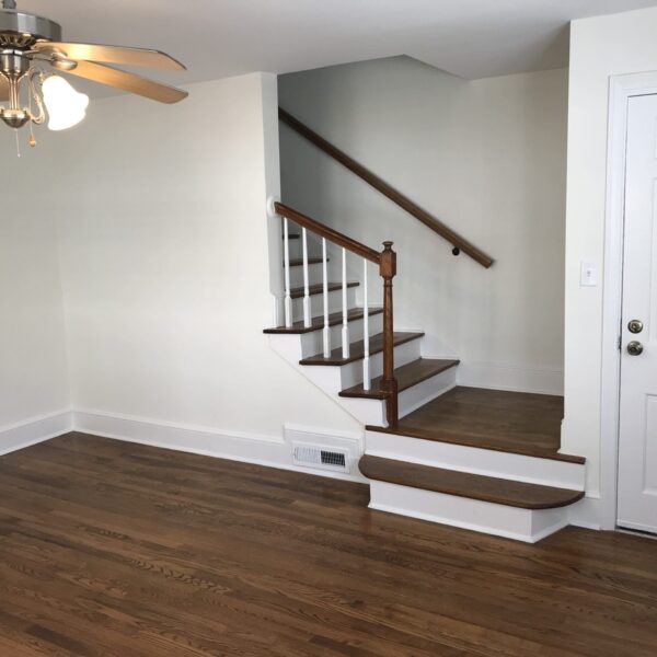 Living room with stair and front door to the unit